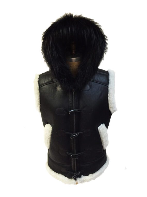A man wearing a black sheepskin vest with a removable fox fur hood and a white shirt.