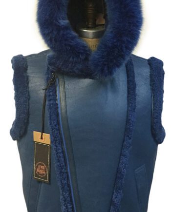 A man wearing a navy sheepskin vest with a removable fox fur hood and a black shirt.
