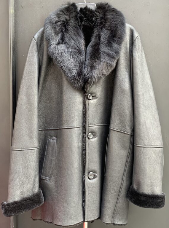 A leather coat with a single button closure and a black fox fur collar.