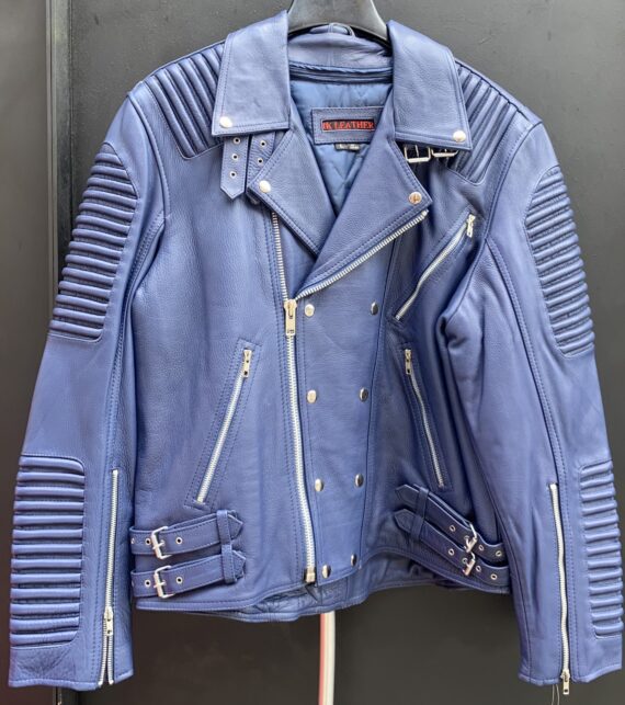 A man wearing a light blue leather jacket with ribbles on the shoulders and sleeves, standing in front of a brick wall. The jacket is made of cowhide leather and has a front zip closure, two side pockets, and a snap button collar.