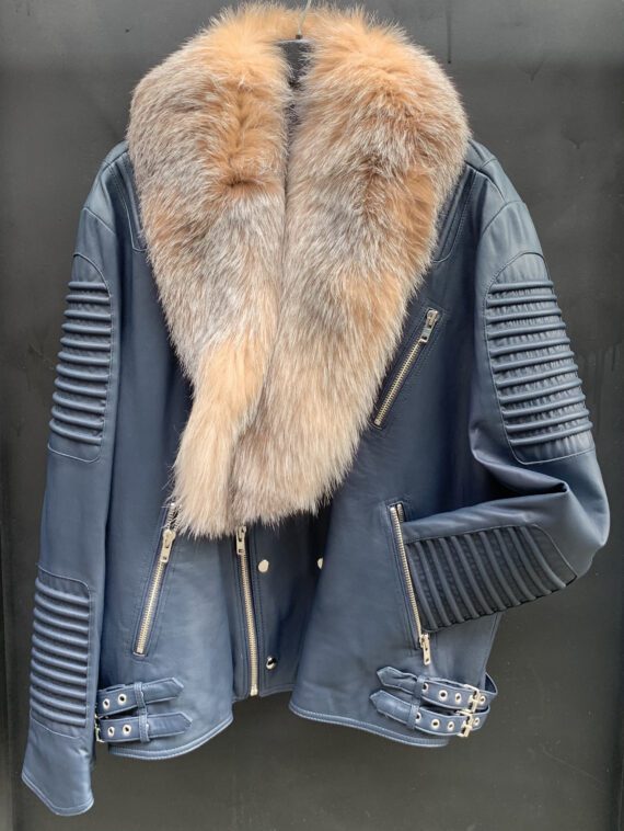 A man wearing a blue leather biker jacket with a crystal fox fur collar and cuffs.