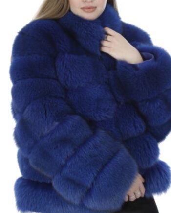 A woman wearing a Sax blue fox fur jacket with a hook and eye closure and two side pockets, looking cozy and stylish.