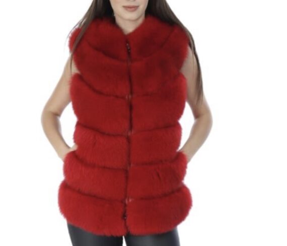 A woman wearing a red fox fur vest with a hook and eye closure and pockets.