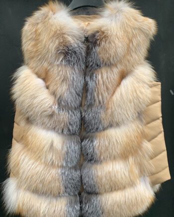 A woman wearing a silver fox fur vest with a hook and eye closure and pockets.