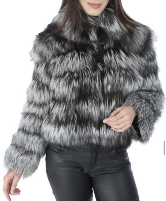 A woman wearing a brown fox fur jacket with a zipper and pockets.