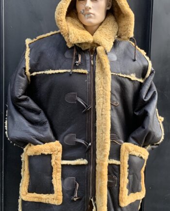 A man wearing a brown Shearling 7/8 coat with a gold zipper and a hood.